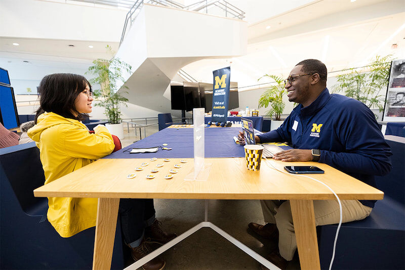 A student sits across the table from a recruiter